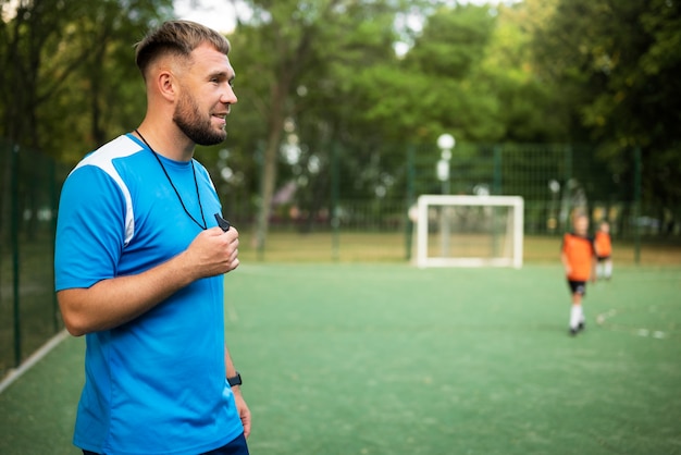 Football trainer teaching his pupils