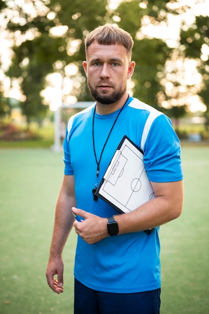 Football trainer teaching his pupils