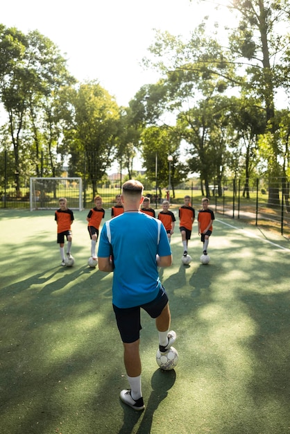 Football trainer teaching his pupils