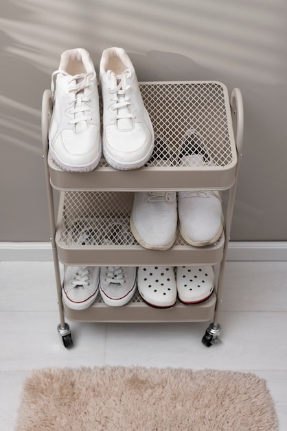 Free photo footwear stacked in shoe rack indoors