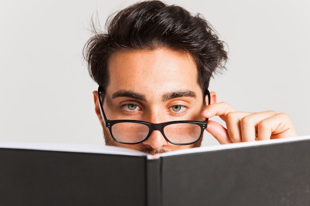 Free Photo foreground man with book and glasses