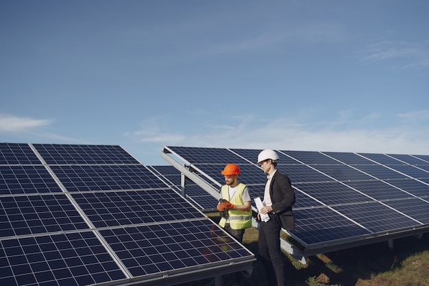 Foreman and businessman at solar energy station.