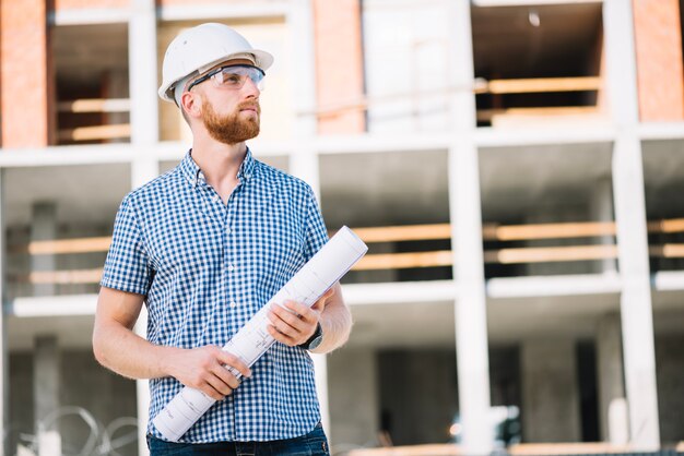 Foreman with blueprints on site