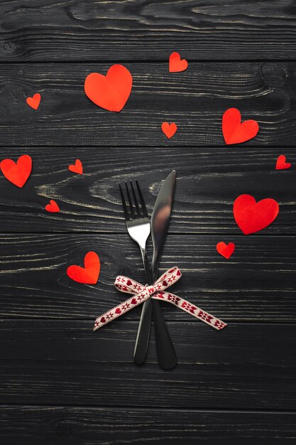 Fork and knife on table with hearts