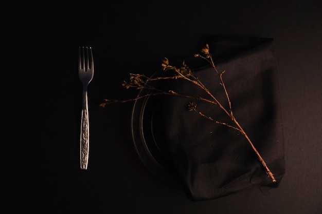 Free Photo fork near plate with twig