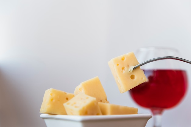 Free photo fork near set of fresh cheese in saucer and glass of wine