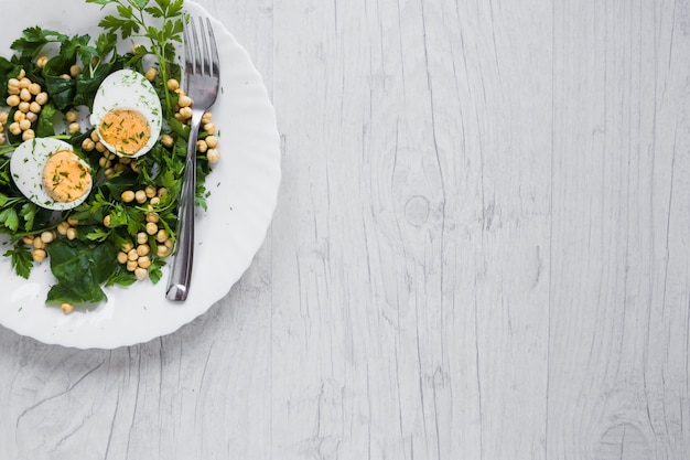 Fork on plate with salad