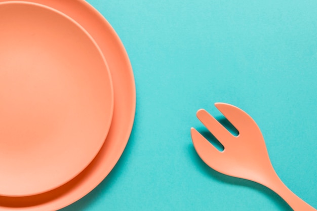 Free Photo fork and plates on blue background