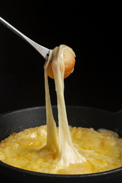 Free photo fork with melted cheese and mushroom