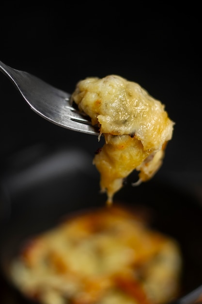 Fork with melted cheese and toast