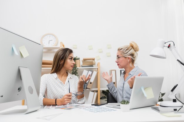 Formal dressed women looking at each other