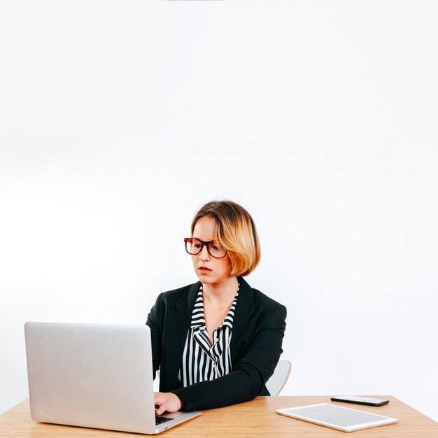 Formal woman working with laptop