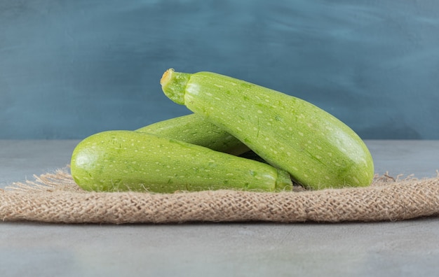 Four fresh zucchini vegetables on a sackcloth . High quality photo