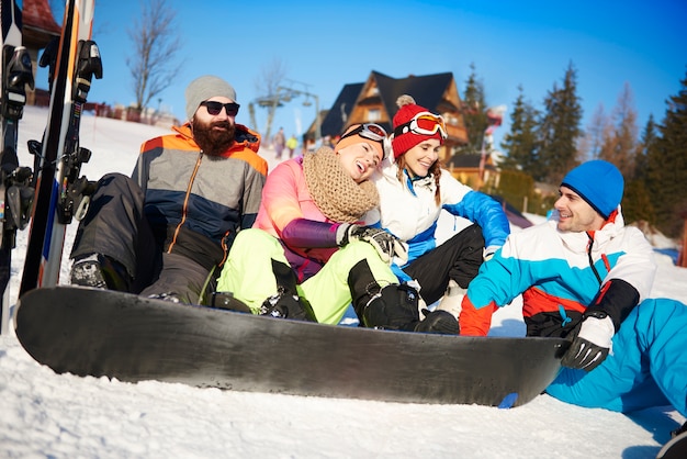 Free Photo four of friends with snowboarders on the snow 
