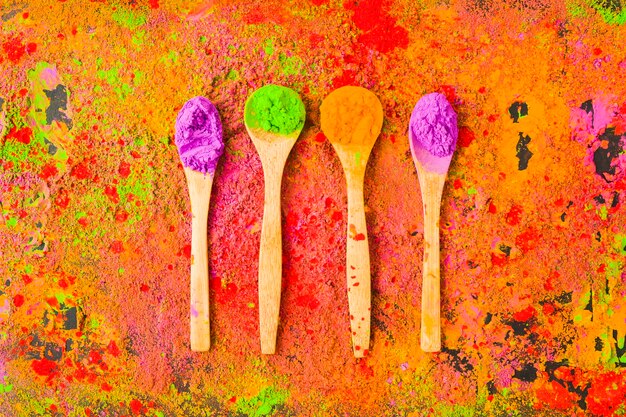 Four spoons with powders on table