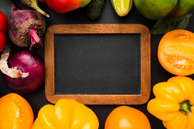 Frame arrangement made of vegetables on dark background