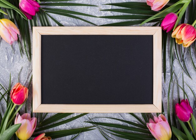 Frame blackboard with flowers along edges