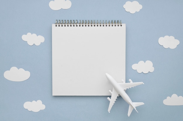 Free Photo frame of clouds with airplane and notebook