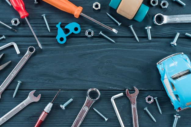 Free Photo frame of different tools and toy car on table