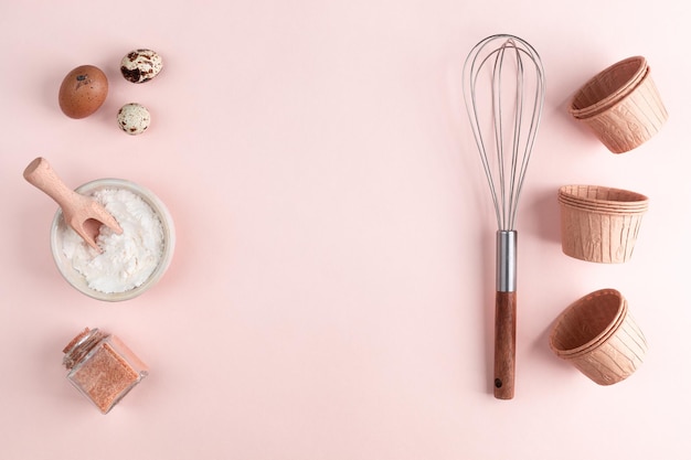 Frame of food ingredients for baking on a gently pink pastel background Cooking flat lay with copy space Top view Baking concept