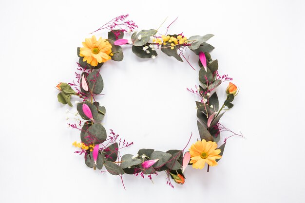 Frame of fresh flowers with green leaves on twigs