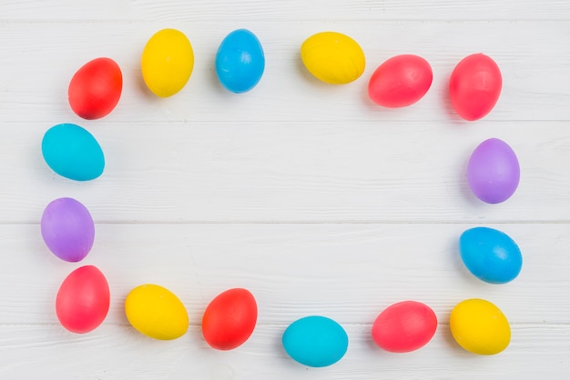 Frame from colorful Easter eggs on table