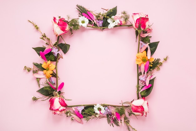 Free photo frame from different flowers on table