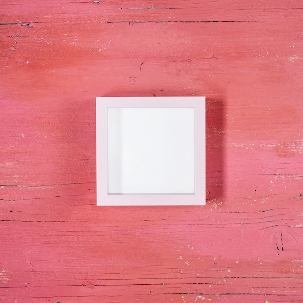 Free photo frame on light pink wooden background