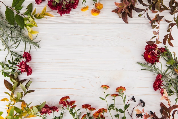 Frame made from different flowers on table