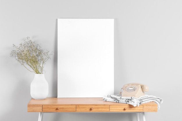 Free photo frame mock up on table beside vase