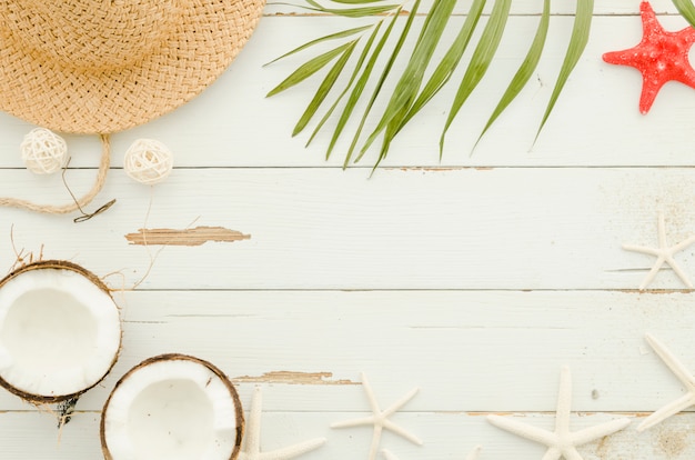 Free photo frame of straw hat, sea stars and palm leaf