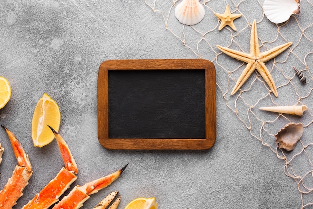 Free photo frame surrounded by seafood on table