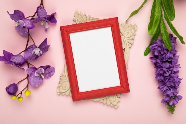 Frame with blooming flowers beside