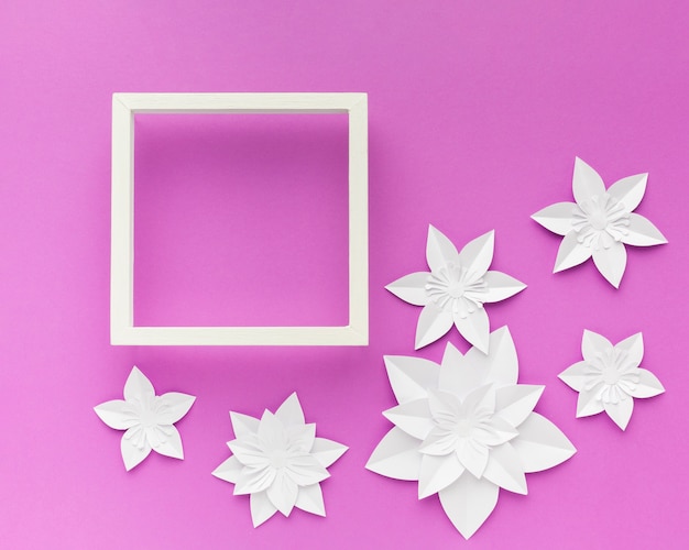 Free photo frame with elegant white paper flowers beside