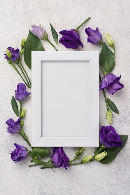 Frame with flowers on table