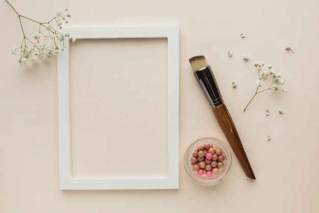 Free photo frame with makeup products on table