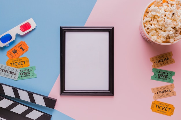 Frame with popcorns and clapperboard