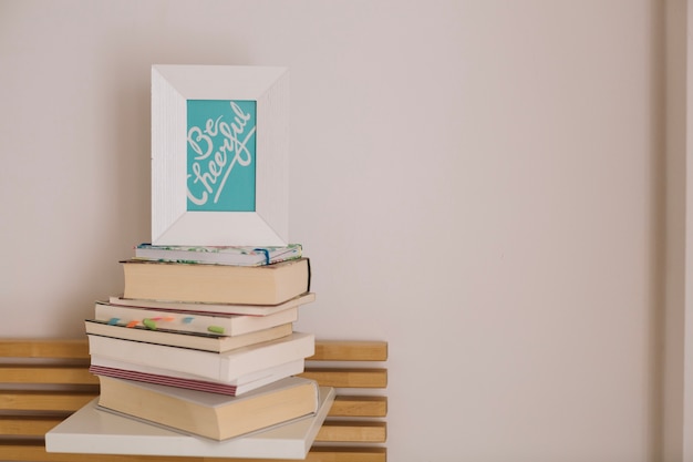 Free Photo frame with writing standing on books