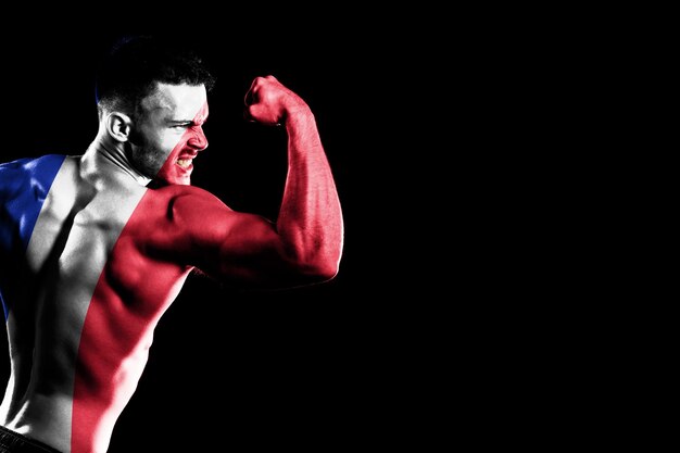 France flag on handsome young muscular man black background