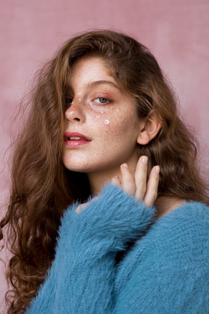 Freckled woman with white flowers on her face