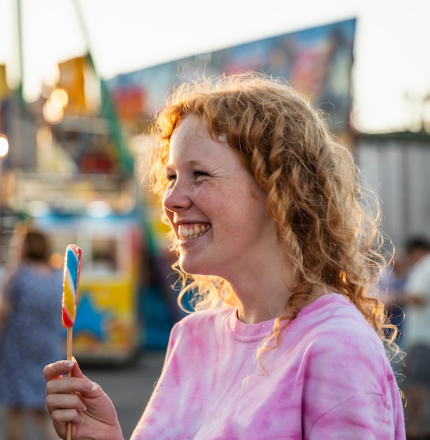 Free Photo freckles smiley woman enjoying a lollipop