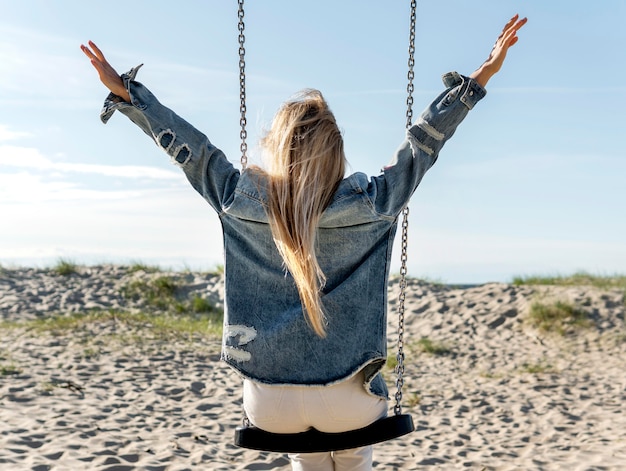 Free photo freedom concept with swing on beach