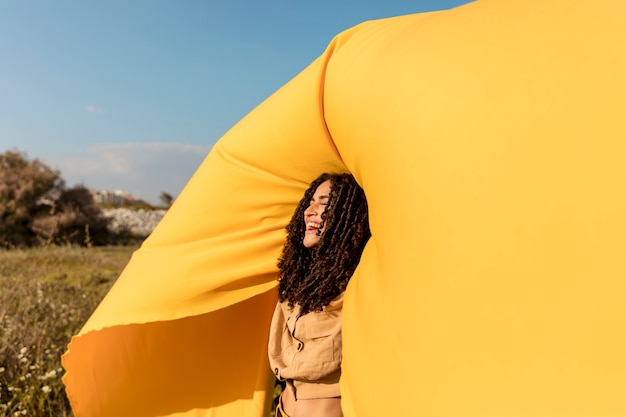 Free photo freedom concept with woman holding cloth in nature