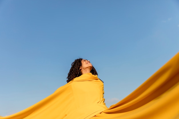 Freedom concept with woman holding cloth in nature