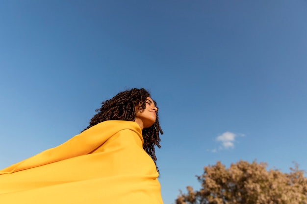 Freedom concept with woman holding cloth in nature