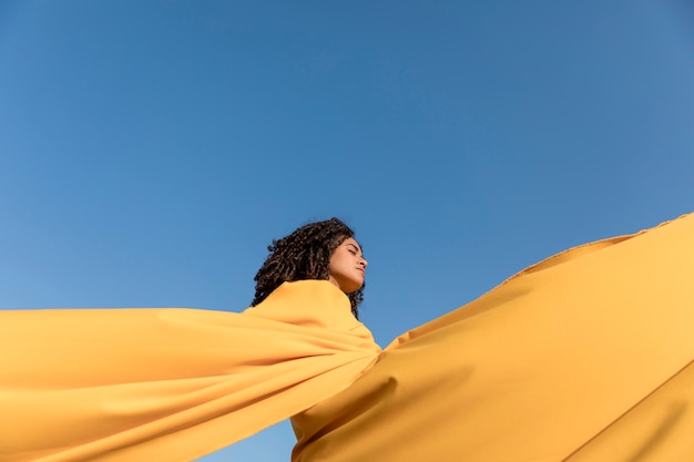 Freedom concept with woman holding cloth in nature