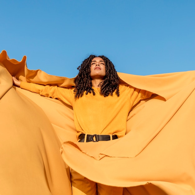 Free photo freedom concept with woman holding cloth in nature