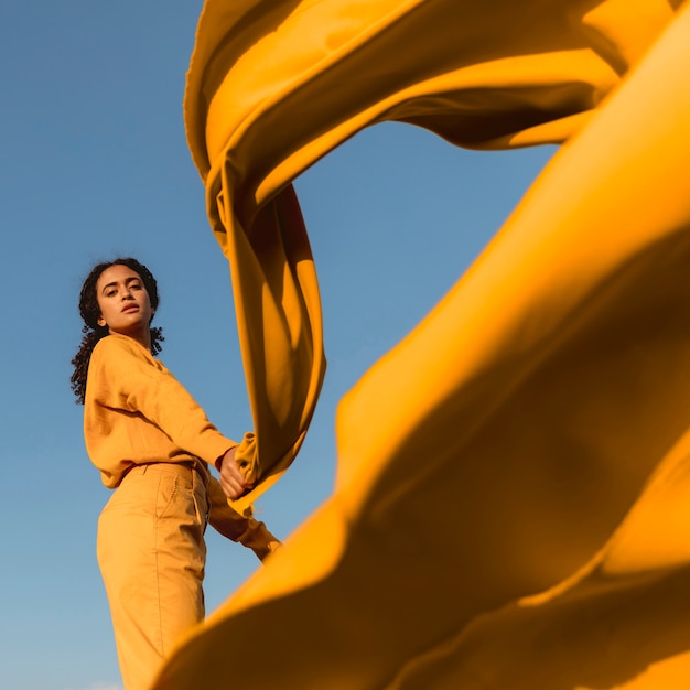 Free photo freedom concept with woman holding cloth in nature