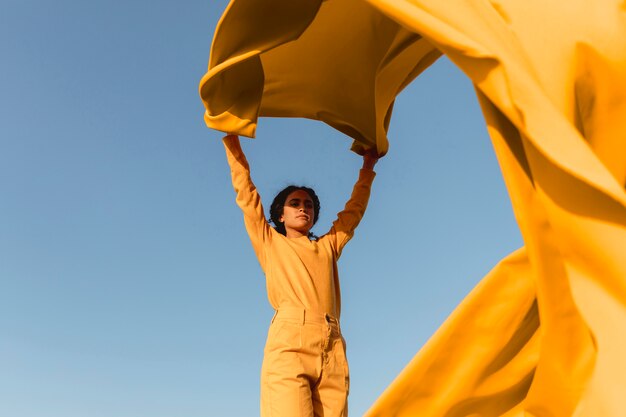 Freedom concept with woman holding cloth in nature