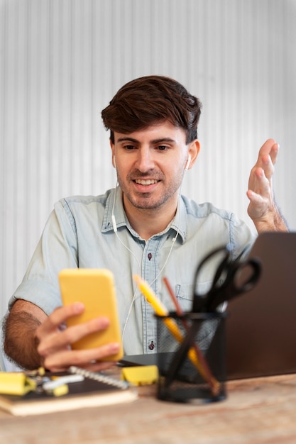 Free Photo freelancer looking on his phone for a project